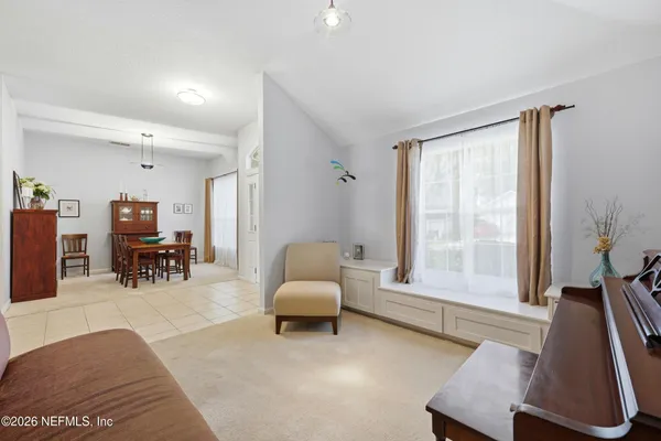 a living room with furniture and a large window