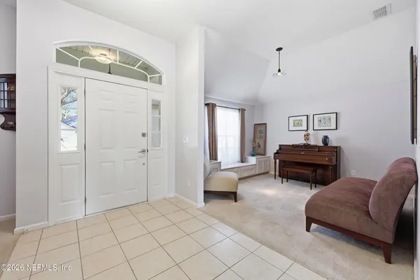 a living room with furniture and a dining table