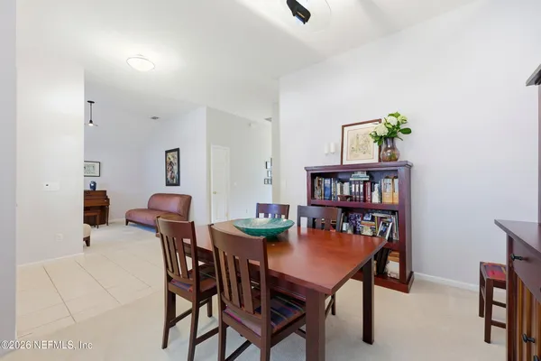 a view of a dining room with furniture and a book shelf
