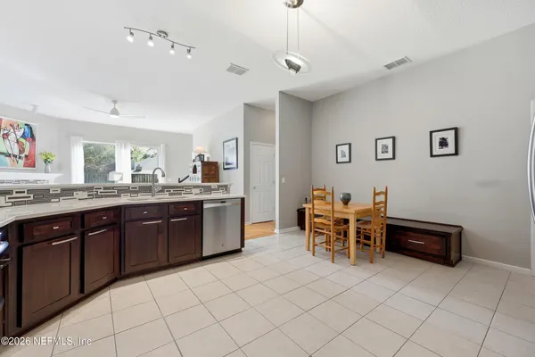 a large kitchen with a table and chairs in it
