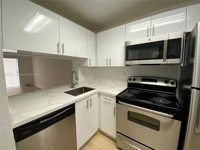 a kitchen with a stove and a microwave