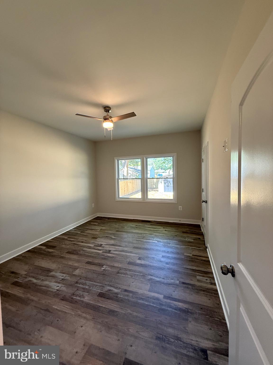 228 Dale Drive Colonial Beach, VA 22443 - Photo 21 of 59 a view of an empty room with wooden floor and a window