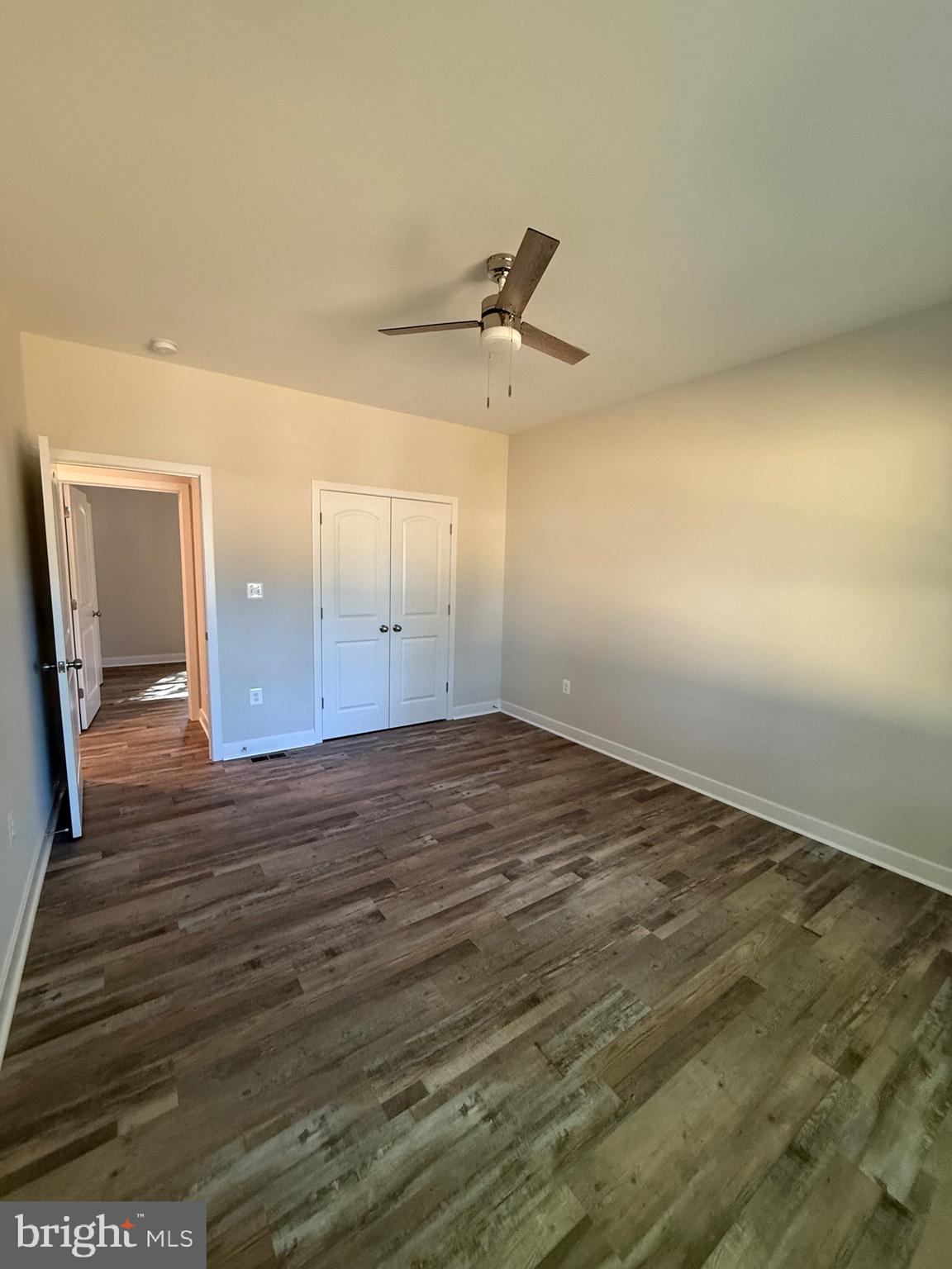 228 Dale Drive Colonial Beach, VA 22443 - Photo 22 of 59 an empty room with wooden floor and windows