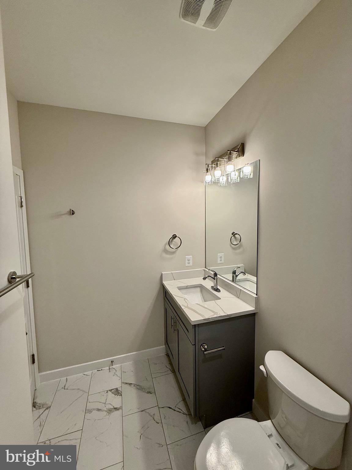 228 Dale Drive Colonial Beach, VA 22443 - Photo 25 of 59 a bathroom with a toilet sink and mirror