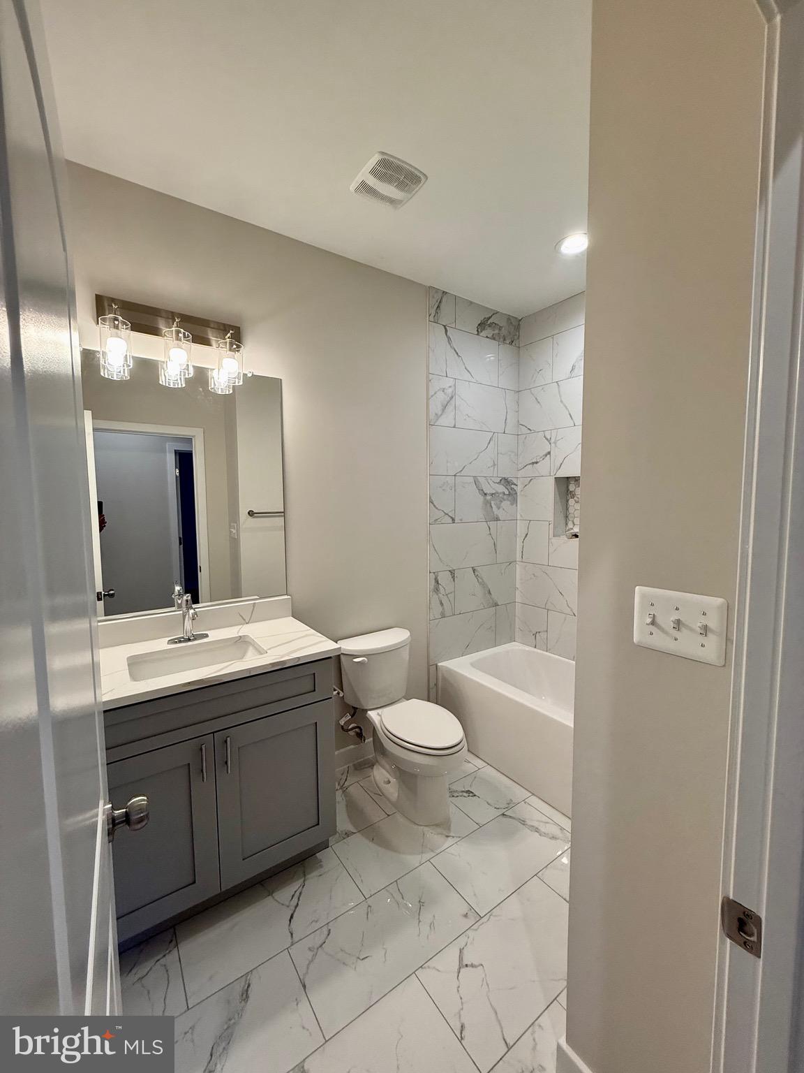 228 Dale Drive Colonial Beach, VA 22443 - Photo 27 of 59 a bathroom with a granite countertop sink toilet mirror and bathtub