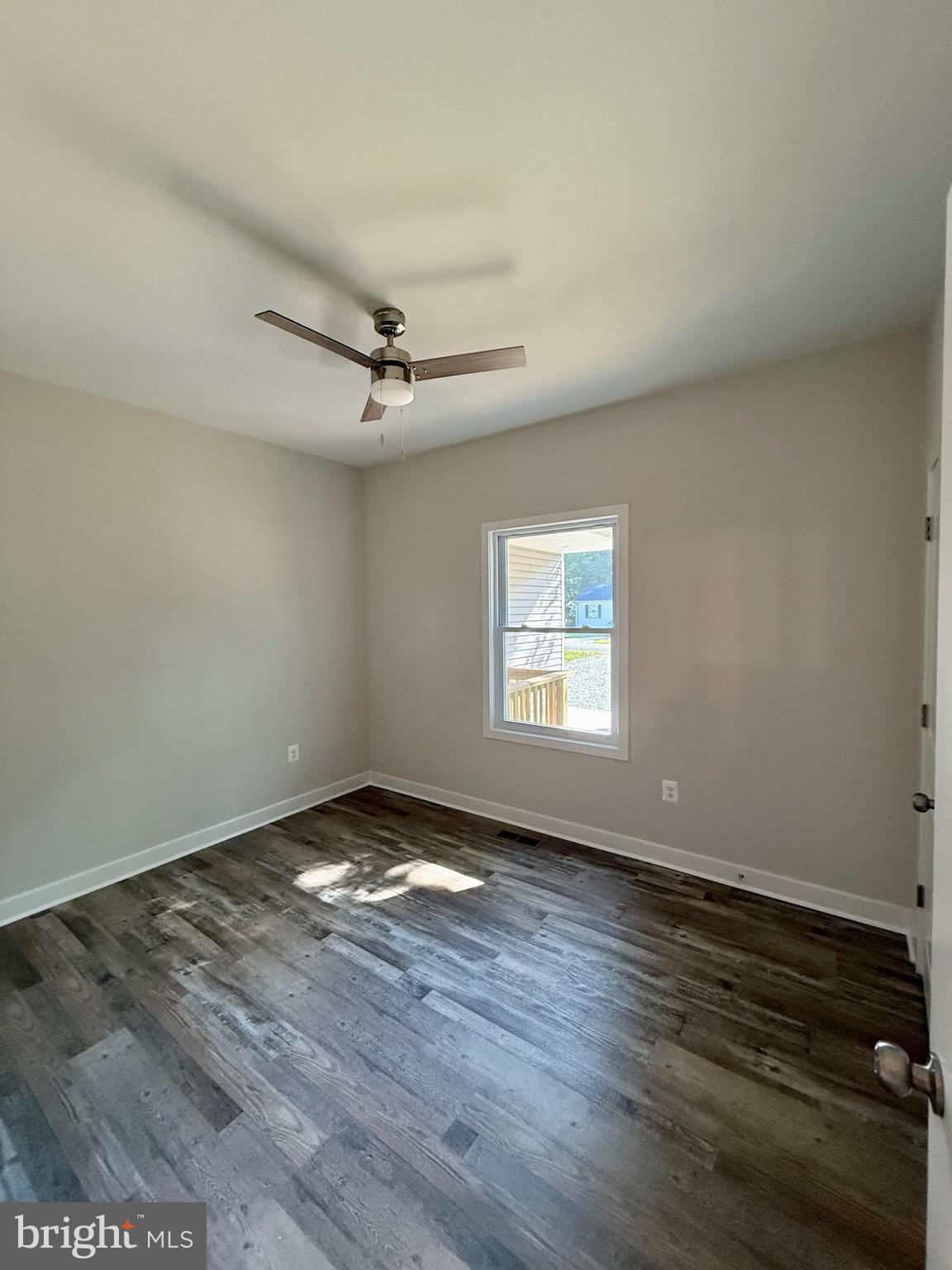 228 Dale Drive Colonial Beach, VA 22443 - Photo 28 of 59 an empty room with wooden floor fan and windows