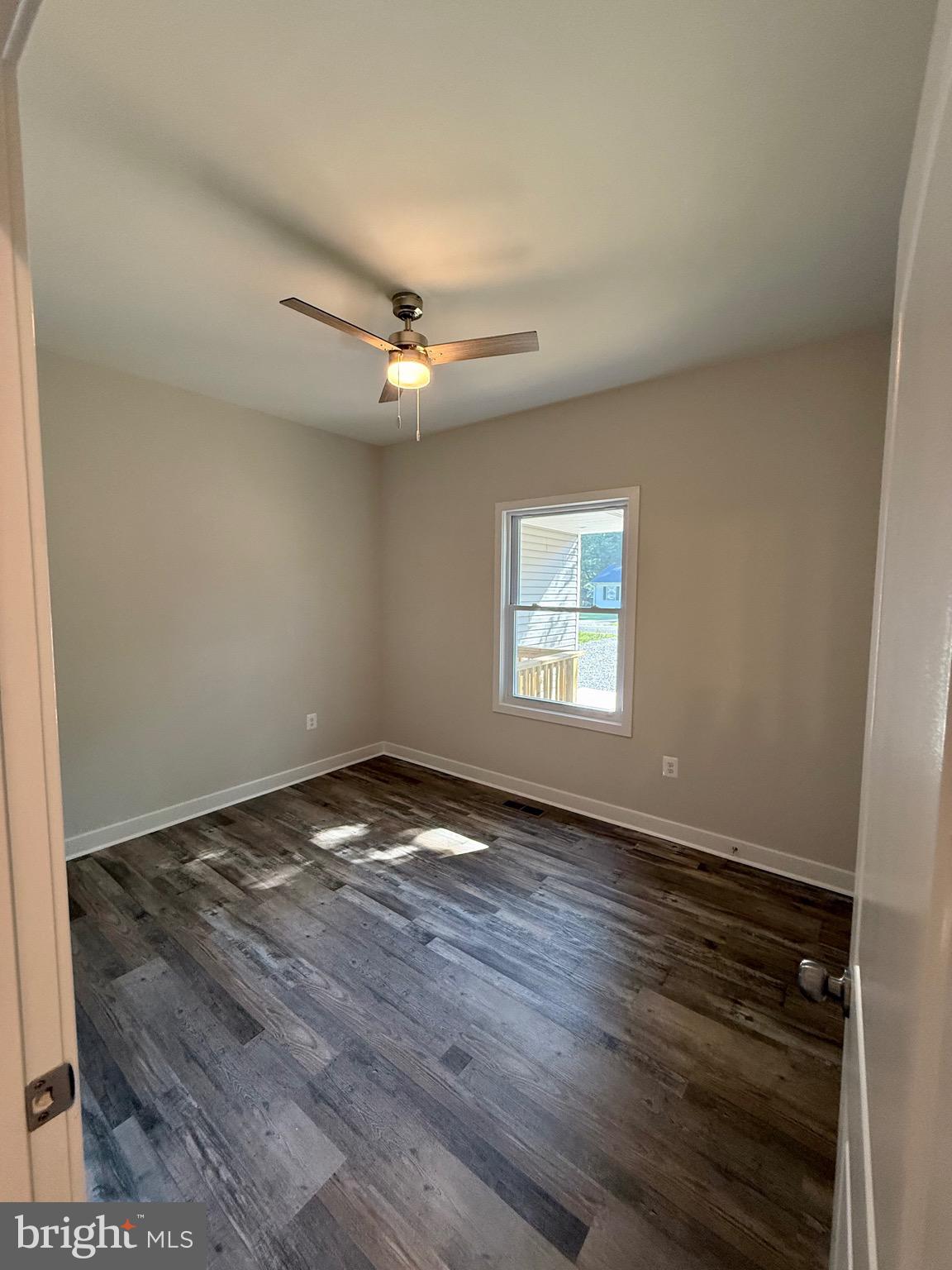 228 Dale Drive Colonial Beach, VA 22443 - Photo 29 of 59 an empty room with wooden floor fan and windows