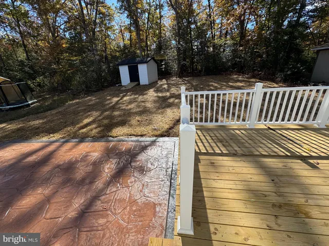 a view of balcony with wooden floor and fence