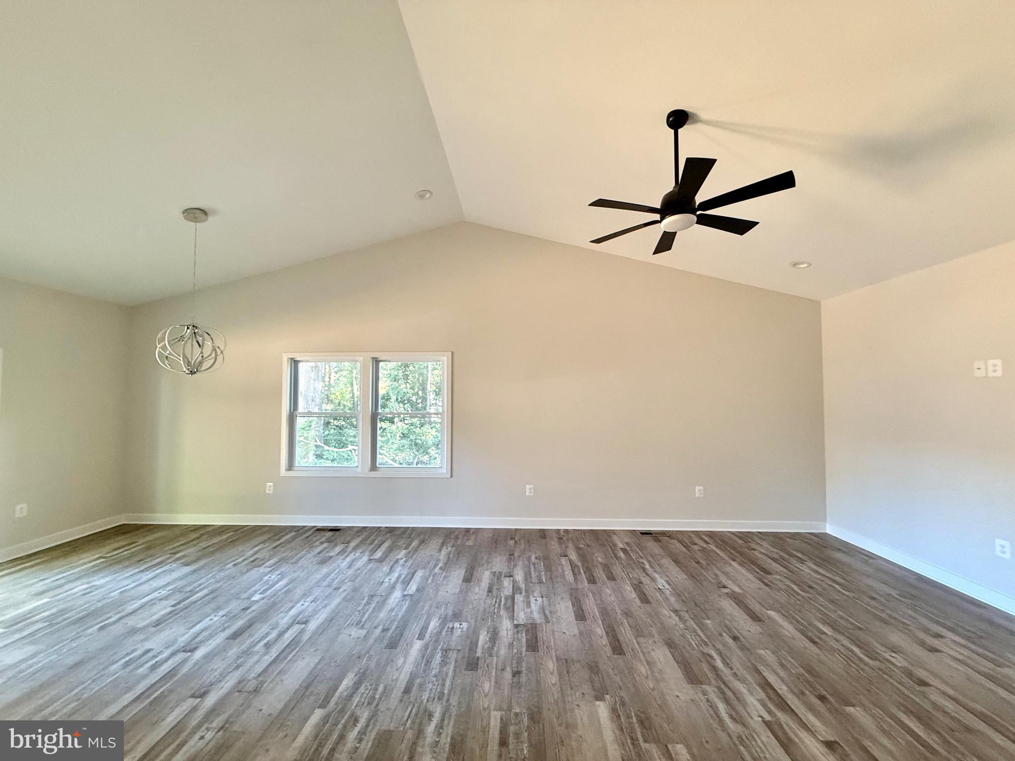228 Dale Drive Colonial Beach, VA 22443 - Photo 5 of 59 wooden floor in an empty room with a window