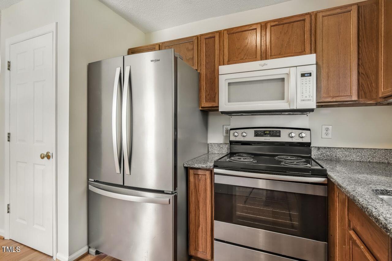 100 Bryant Drive Smithfield, NC 27577 - Photo 14 of 34 a kitchen with refrigerator stove and cabinets