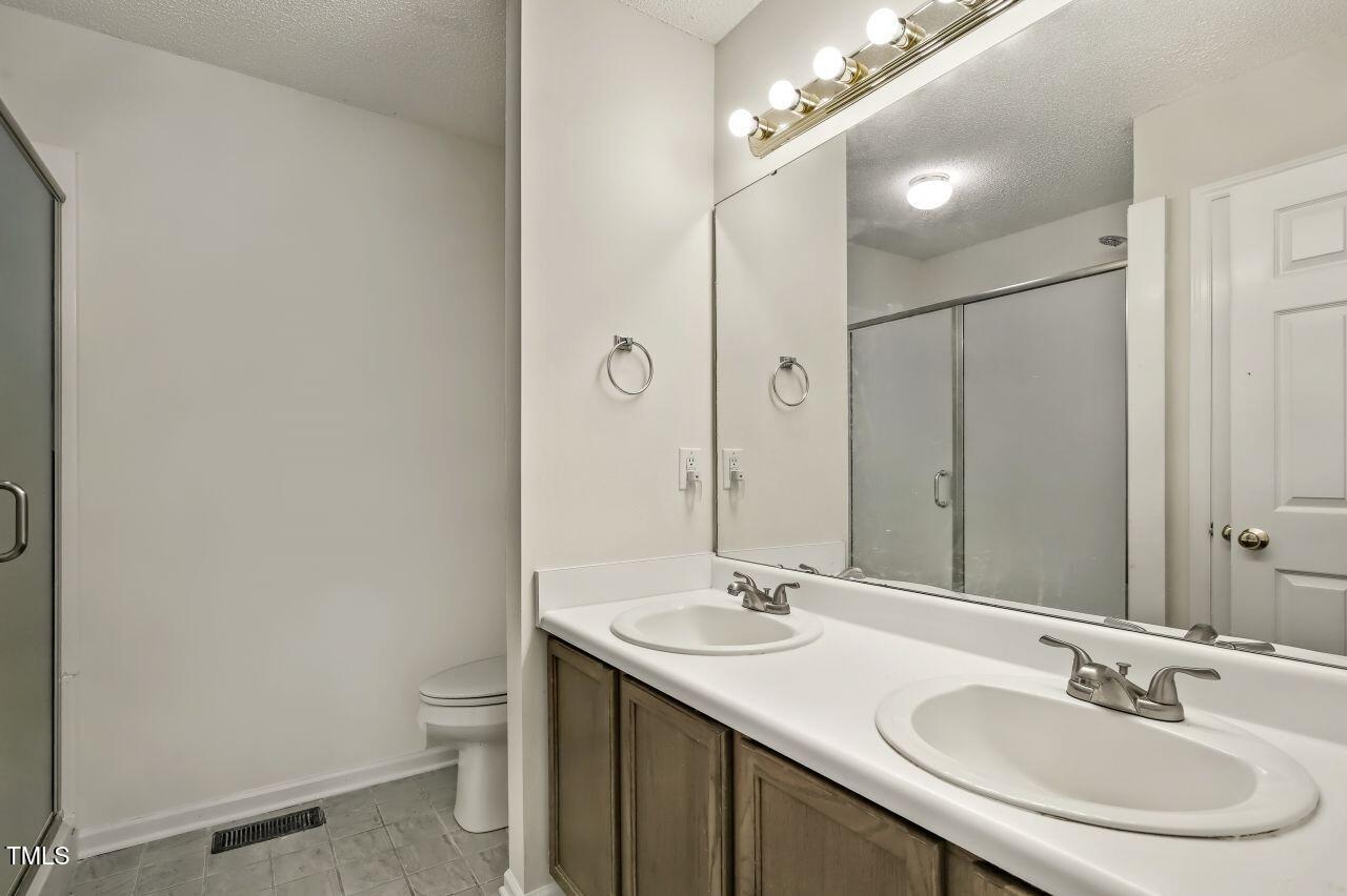 100 Bryant Drive Smithfield, NC 27577 - Photo 22 of 34 a bathroom with a sink double vanity and a mirror