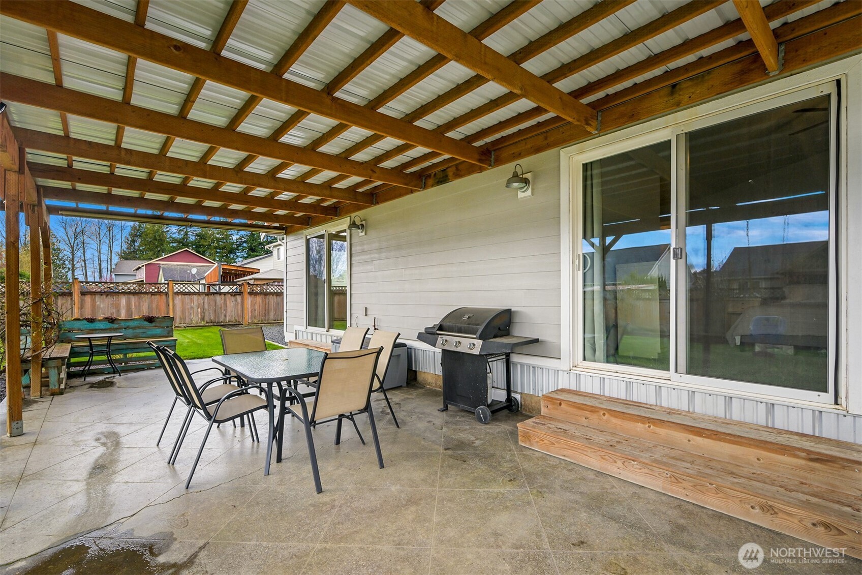 405 Jackson Court Nooksack, WA 98276 - Photo 19 of 28 a patio with a table and chairs