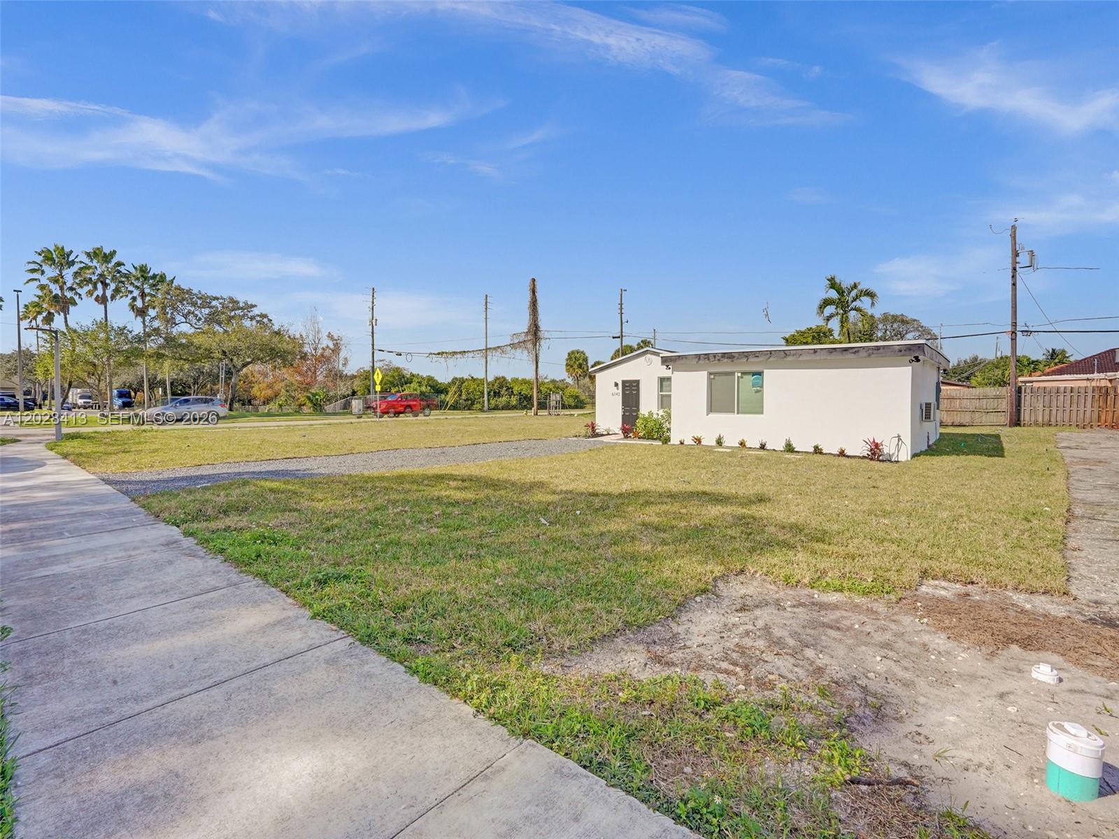 6147 Southwest 40th Street Miramar, FL 33023 - Photo 3 of 4 a front view of a house with a big yard