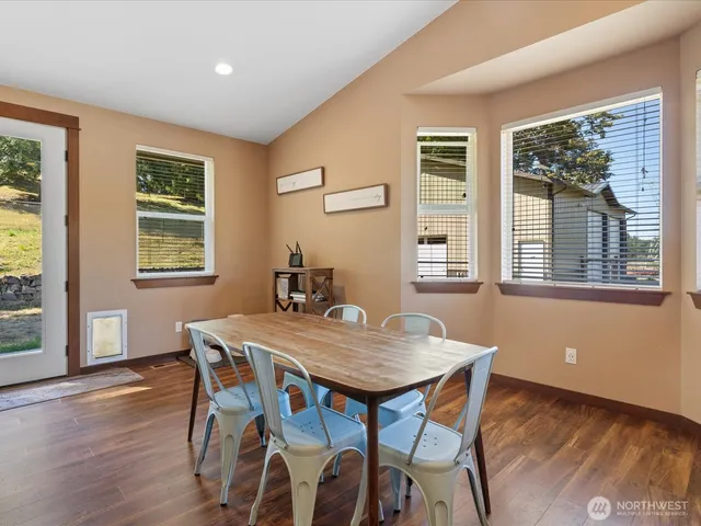 a view of a dining room with furniture window and wooden floor