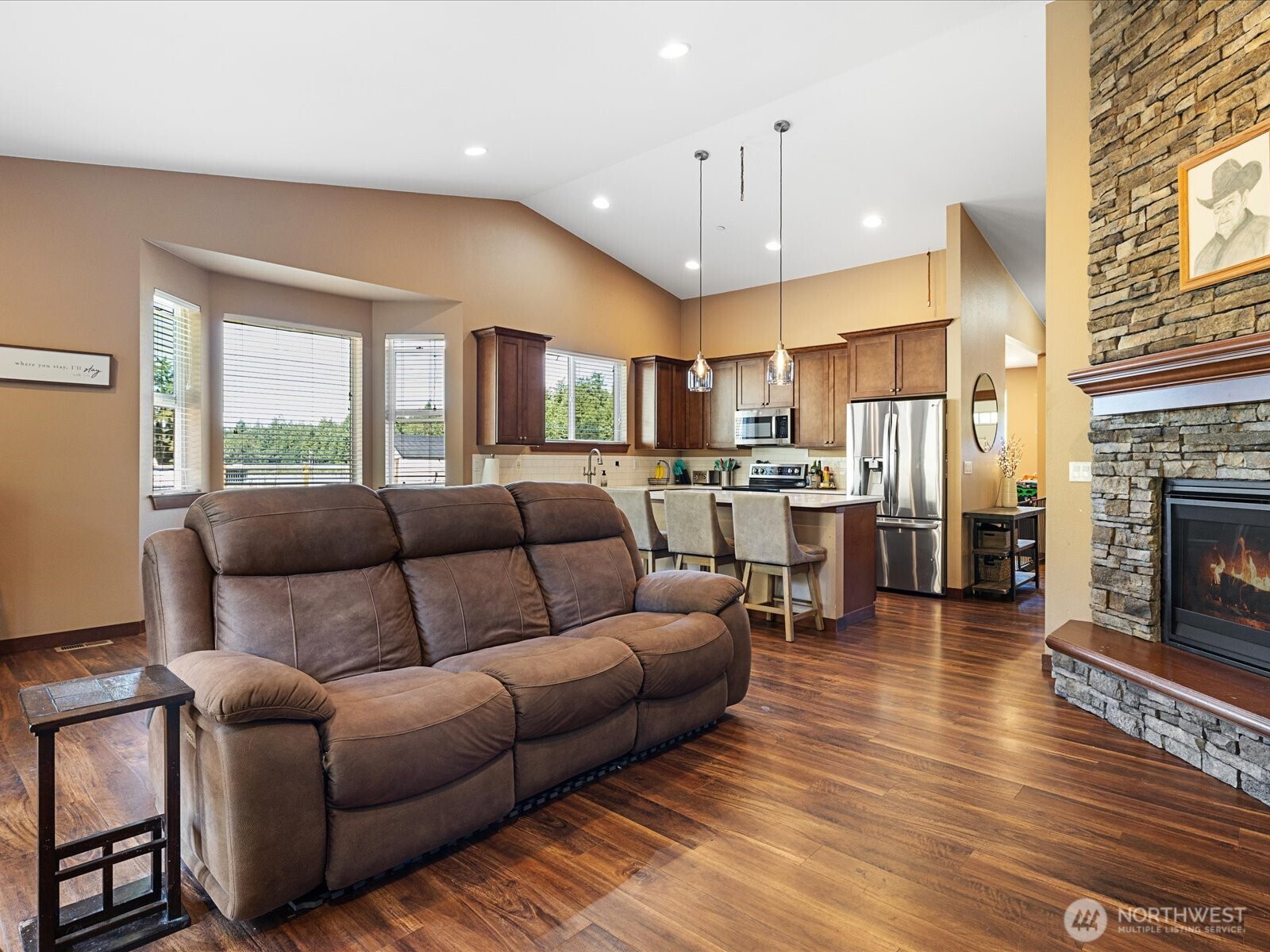606 288th Street East Roy, WA 98580 - Photo 15 of 37 a living room with furniture a fireplace and a flat screen tv