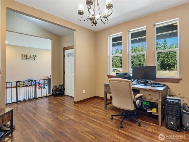 a view of a workspace with furniture and a window