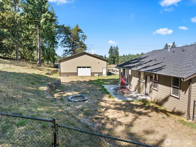a view of a house with backyard and sitting area