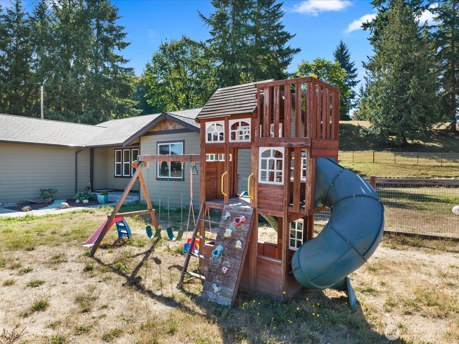606 288th Street East Roy, WA 98580 - Photo 28 of 37 a view of a house with wooden fence