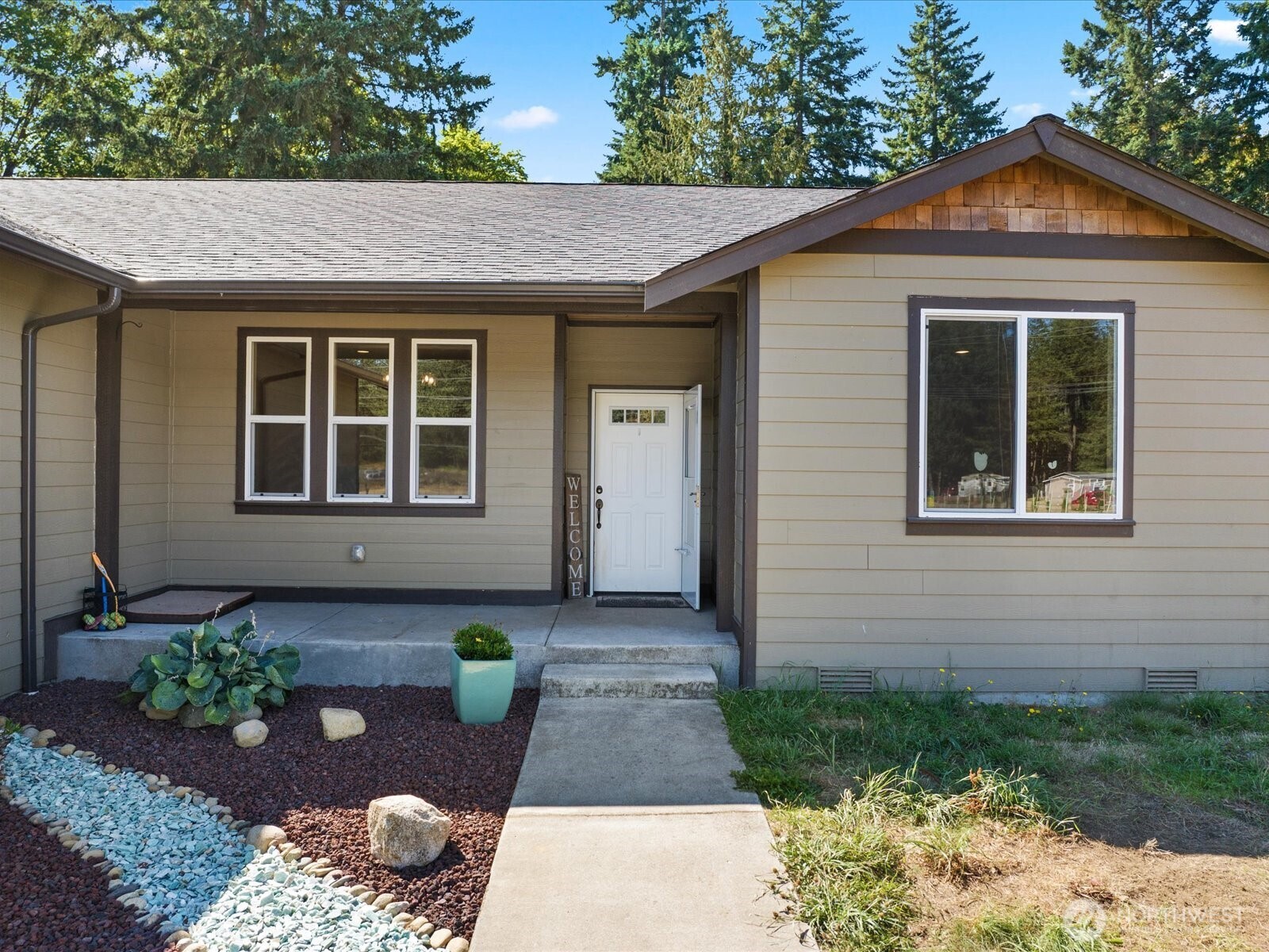606 288th Street East Roy, WA 98580 - Photo 3 of 37 a front view of a house with garden