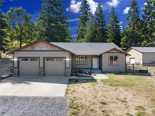 a front view of a house with a yard covered in snow