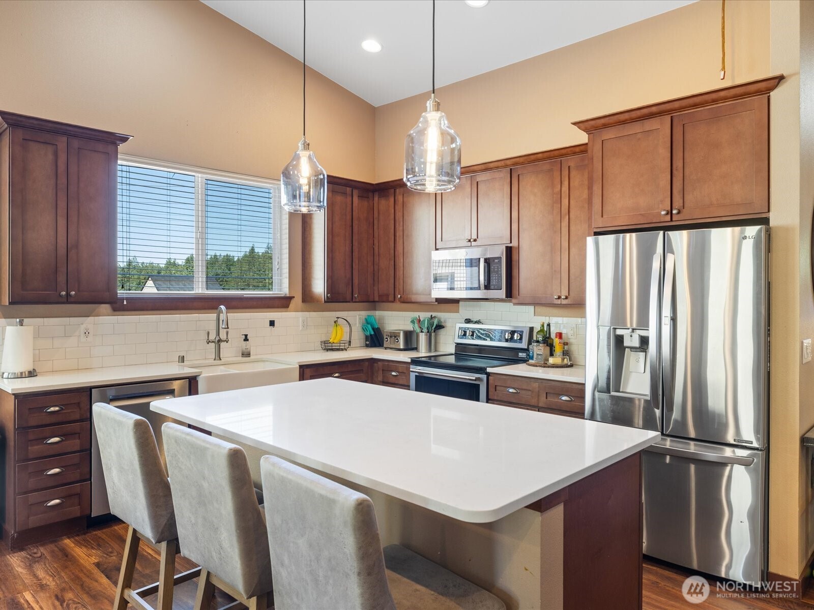 606 288th Street East Roy, WA 98580 - Photo 7 of 37 a kitchen with a refrigerator a sink and cabinets