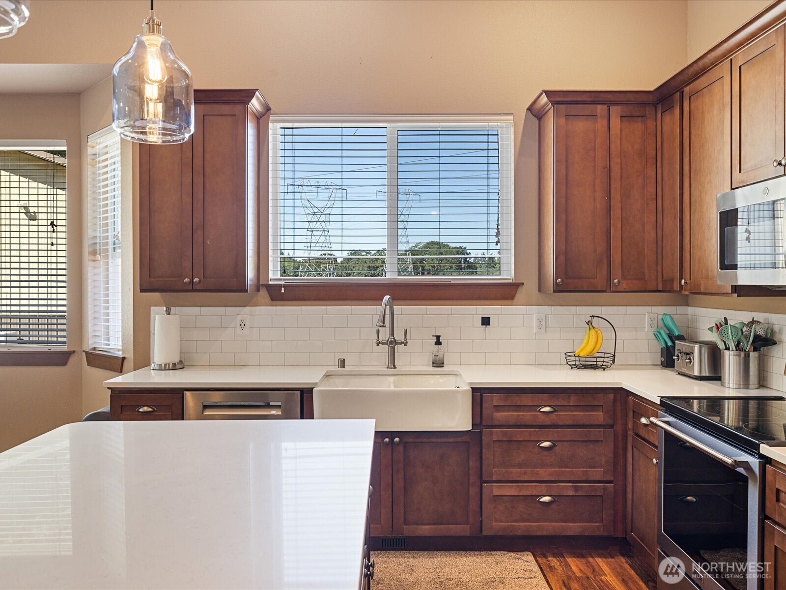 606 288th Street East Roy, WA 98580 - Photo 8 of 37 a kitchen with stainless steel appliances a sink window and cabinets
