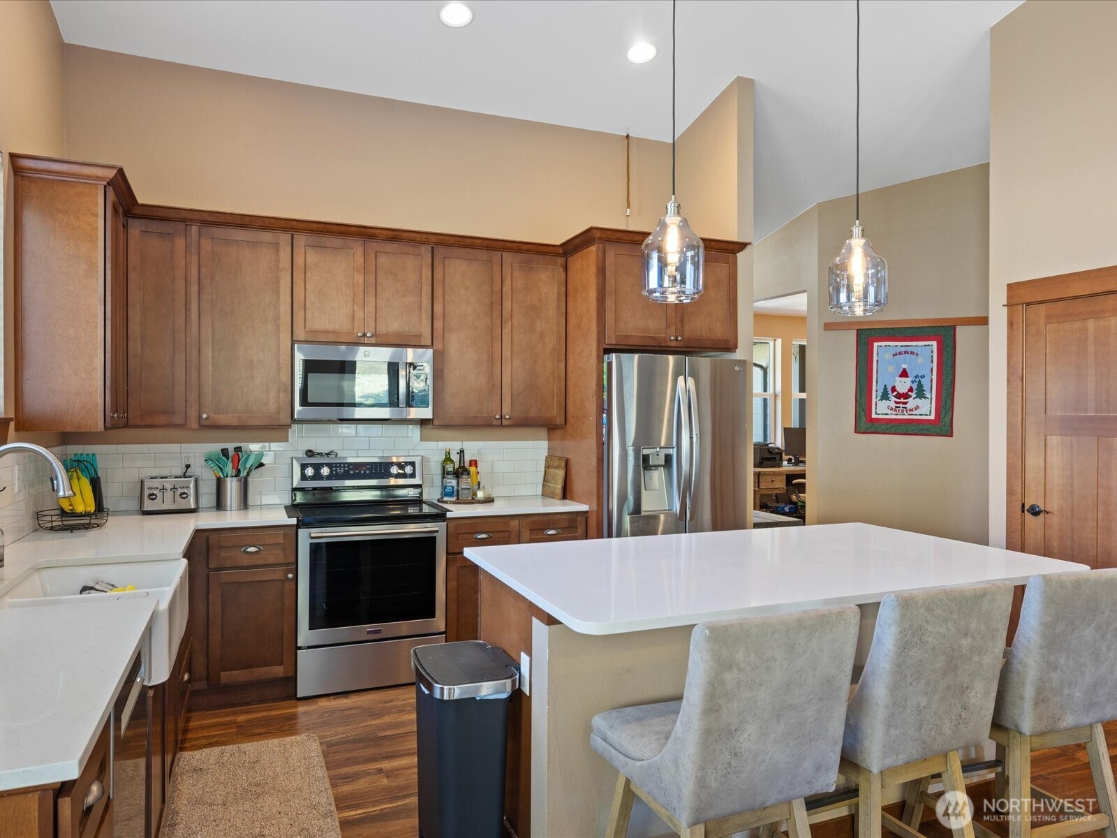 606 288th Street East Roy, WA 98580 - Photo 10 of 37 a kitchen with stainless steel appliances granite countertop a sink a stove a refrigerator cabinets and chairs