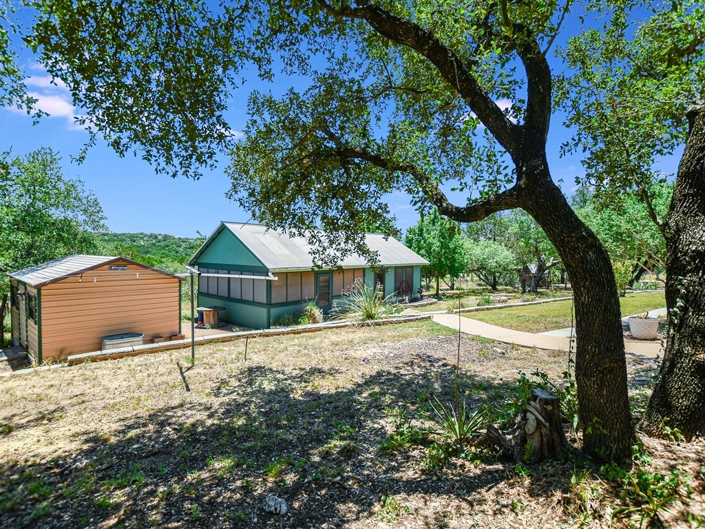 254 Middleton Road Spicewood, TX 78669 - Photo 31 of 32 a view of a house with a tree in the yard
