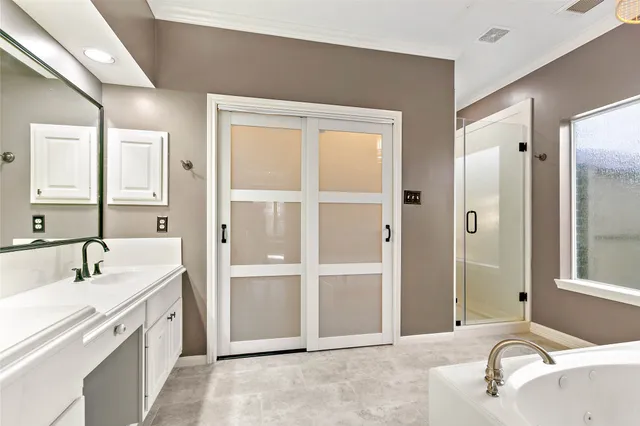 a spacious bathroom with a granite countertop sink and a mirror