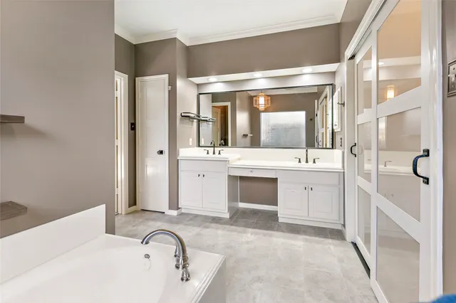 a bathroom with a granite countertop sink mirror and bathtub