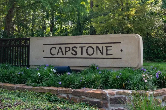 a sign broad in front of flowers