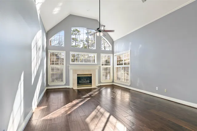 a view of an empty room with a fireplace and a window