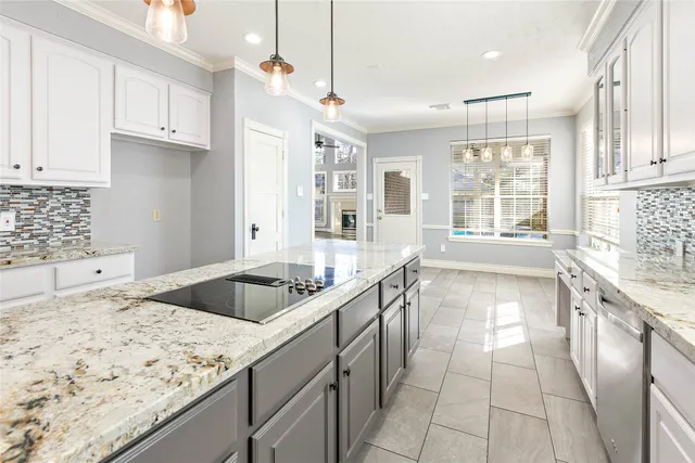a kitchen with granite countertop a sink and a stove top oven