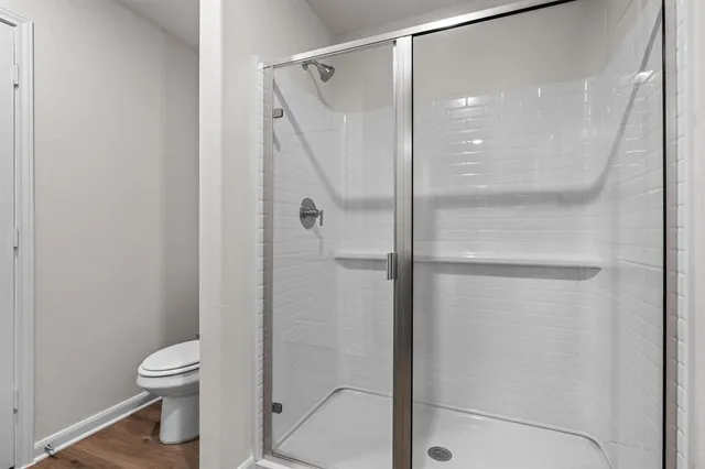 a bathroom that has a glass shower door