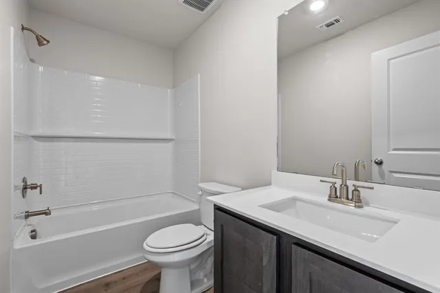 a bathroom with a sink a toilet and a bathtub