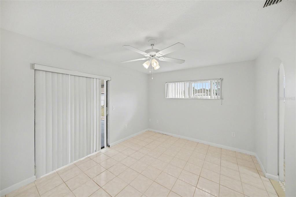 113 Ruskin Avenue Spring Hill, FL 34606 - Photo 16 of 32 a view of an empty room with chandelier fan
