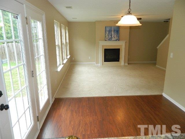5822 Finestra Way Raleigh, NC 27610 - Photo 8 of 25 a view of an empty room with wooden floor and a window