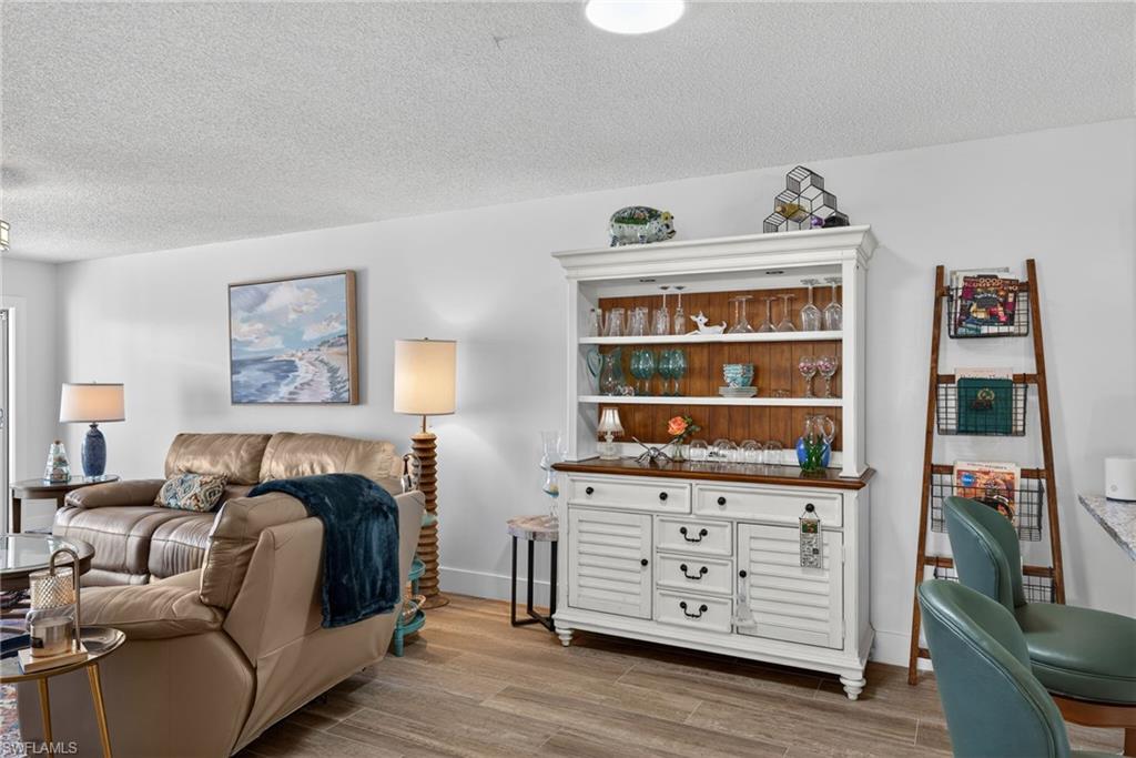 3665 Amberly Circle, Unit B101 Naples, FL 34112 - Photo 11 of 30 a bed room with a bed and a window