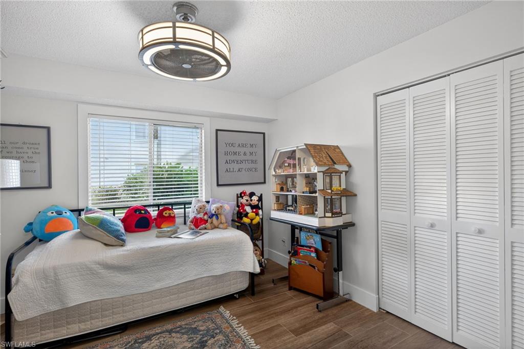 3665 Amberly Circle, Unit B101 Naples, FL 34112 - Photo 19 of 30 a bedroom with a bed and a window