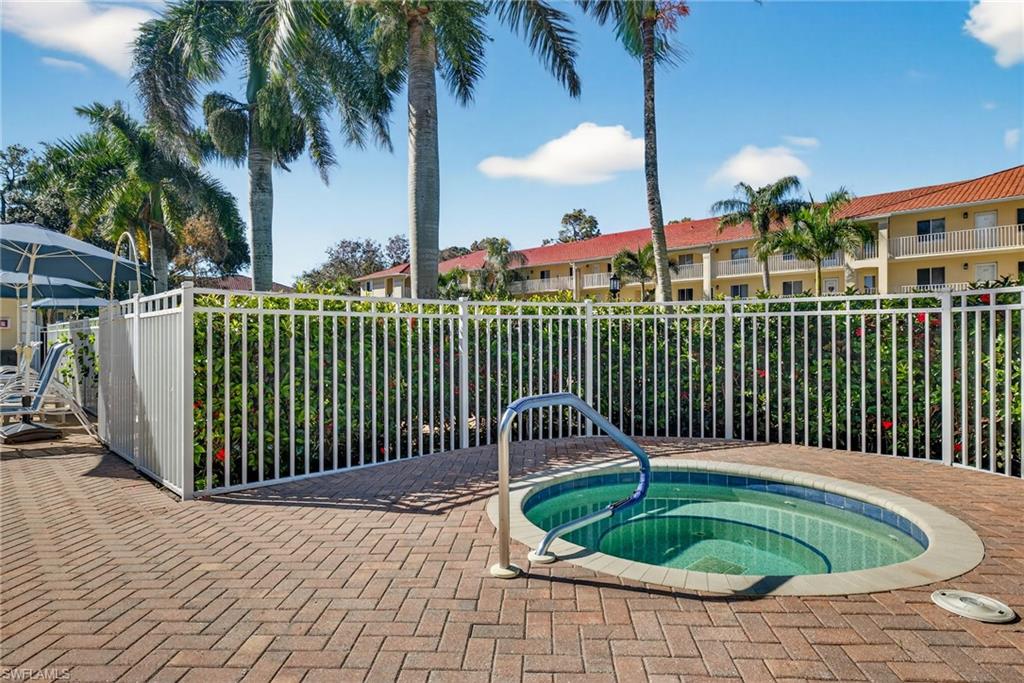 3665 Amberly Circle, Unit B101 Naples, FL 34112 - Photo 26 of 30 a front view of a house with a garden