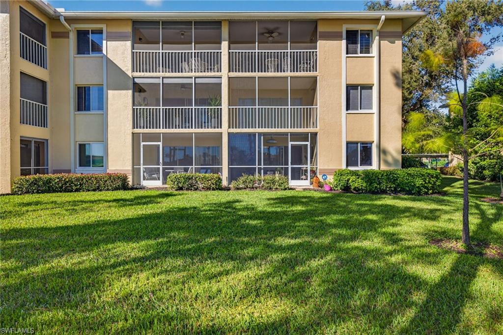 3665 Amberly Circle, Unit B101 Naples, FL 34112 - Photo 30 of 30 a front view of a building with a garden