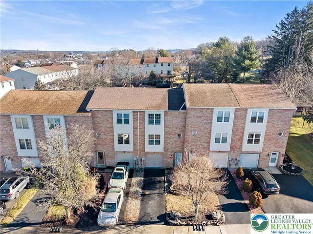a aerial view of a residential apartment building with a yard