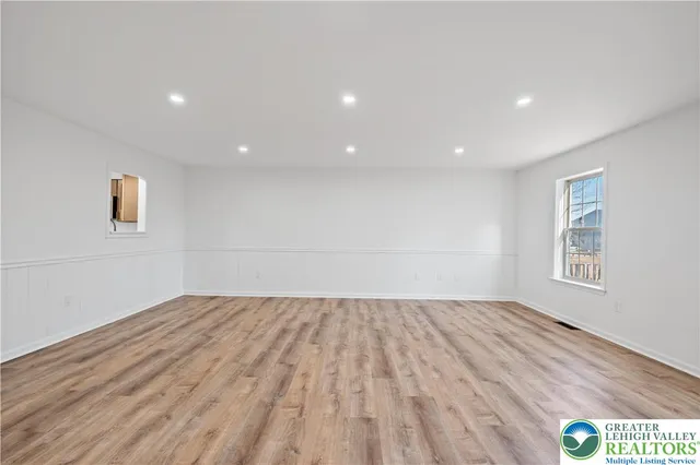 a view of room with window and hardwood floor