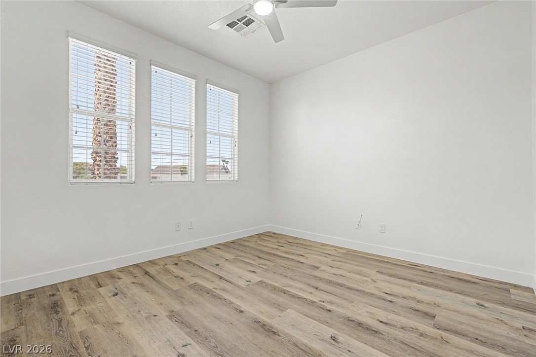 835 Entrada Ridge Avenue Henderson, NV 89012 - Photo 20 of 34 Natural light pours into this adaptable space, featuring light wood-look flooring and a ceiling fan for comfort.
