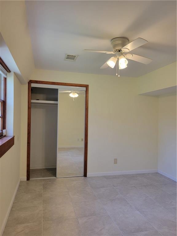 3009 Caldwell Road Northeast Brookhaven, GA 30319 - Photo 16 of 22 an empty room with closet and a chandelier fan