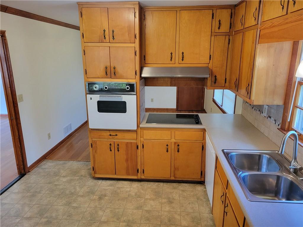 3009 Caldwell Road Northeast Brookhaven, GA 30319 - Photo 4 of 22 a kitchen with stainless steel appliances granite countertop a sink a stove and a refrigerator