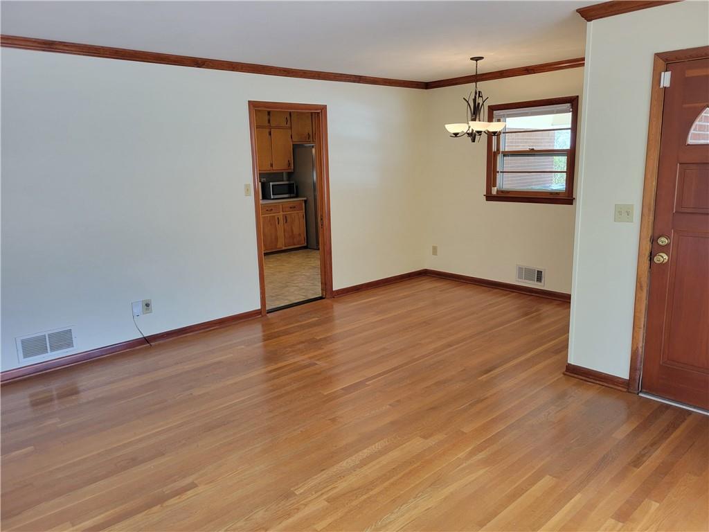 3009 Caldwell Road Northeast Brookhaven, GA 30319 - Photo 8 of 22 an empty room with wooden floor closet and windows
