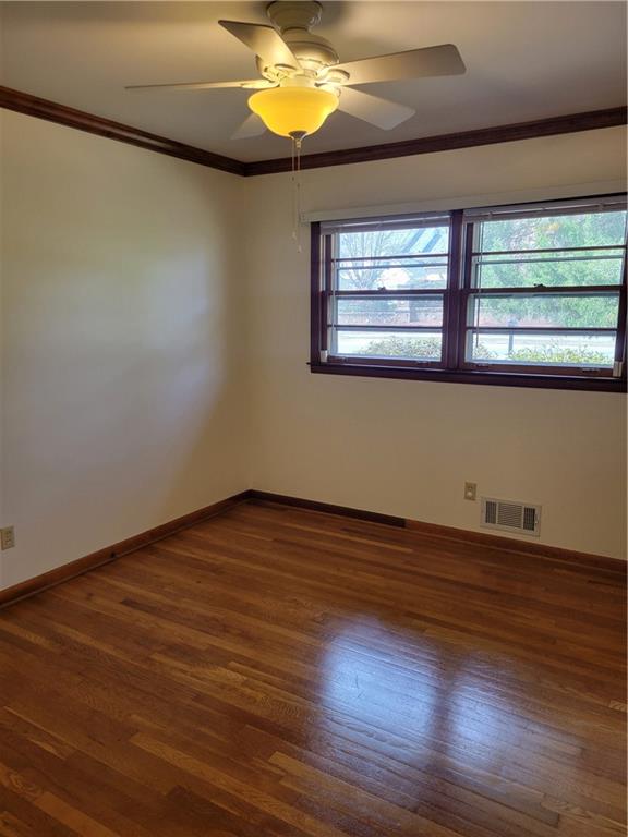 3009 Caldwell Road Northeast Brookhaven, GA 30319 - Photo 9 of 22 a view of empty room with wooden floor and fan