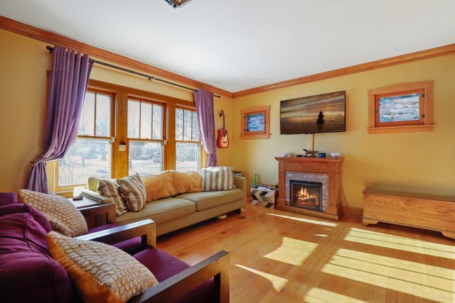 102 Northgate Road Riverside, IL 60546 - Photo 2 of 45 a living room with furniture a flat screen tv and a fireplace