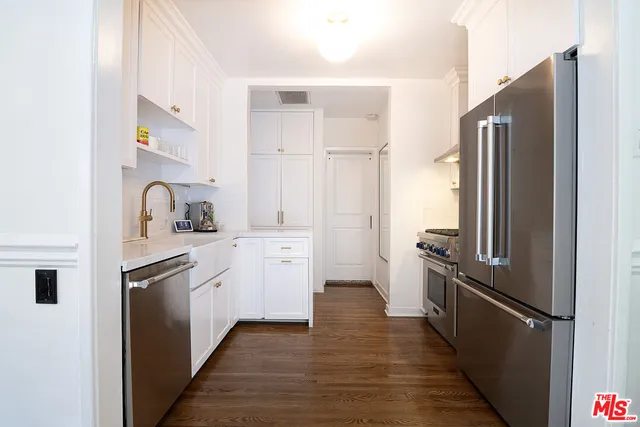 a kitchen with stainless steel appliances granite countertop a stove and a refrigerator